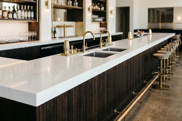 Cocktail bar top in white Caesarstone quartz with undermount bar sinks